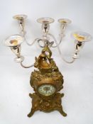 A 19th century French gilt spelter mantel clock together with a plated five-way candelabrum.