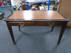 An Edwardian writing table fitted with two drawers