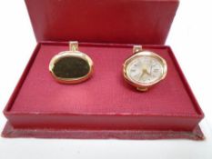 Boxed gent's cuff links, one with inset watch.
