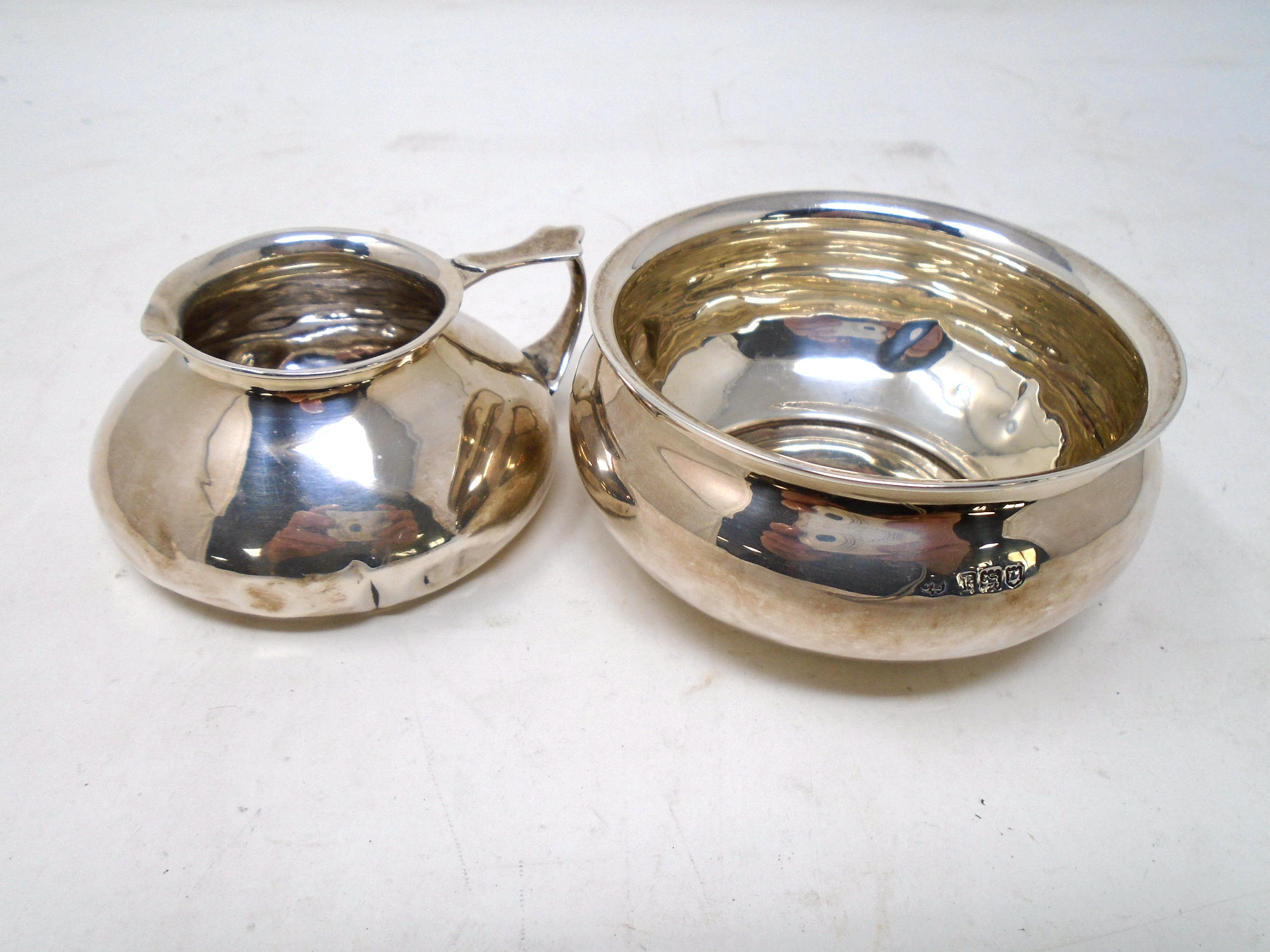 A London silver milk jug with sugar basin.