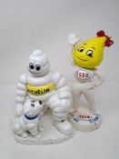 Two cast iron figures Esso Abby Slick and Michelin man with dog.