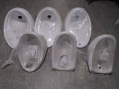 Six Armitage Shanks ceramic urinals.