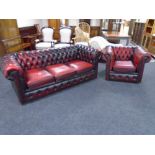 A Chesterfield three seater settee with matching armchair in oxblood buttoned leather