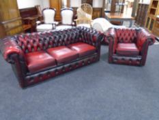 A Chesterfield three seater settee with matching armchair in oxblood buttoned leather