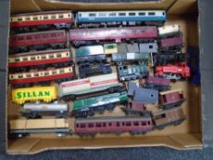 A box containing assorted rolling stock by Airfix and Tri-ang.