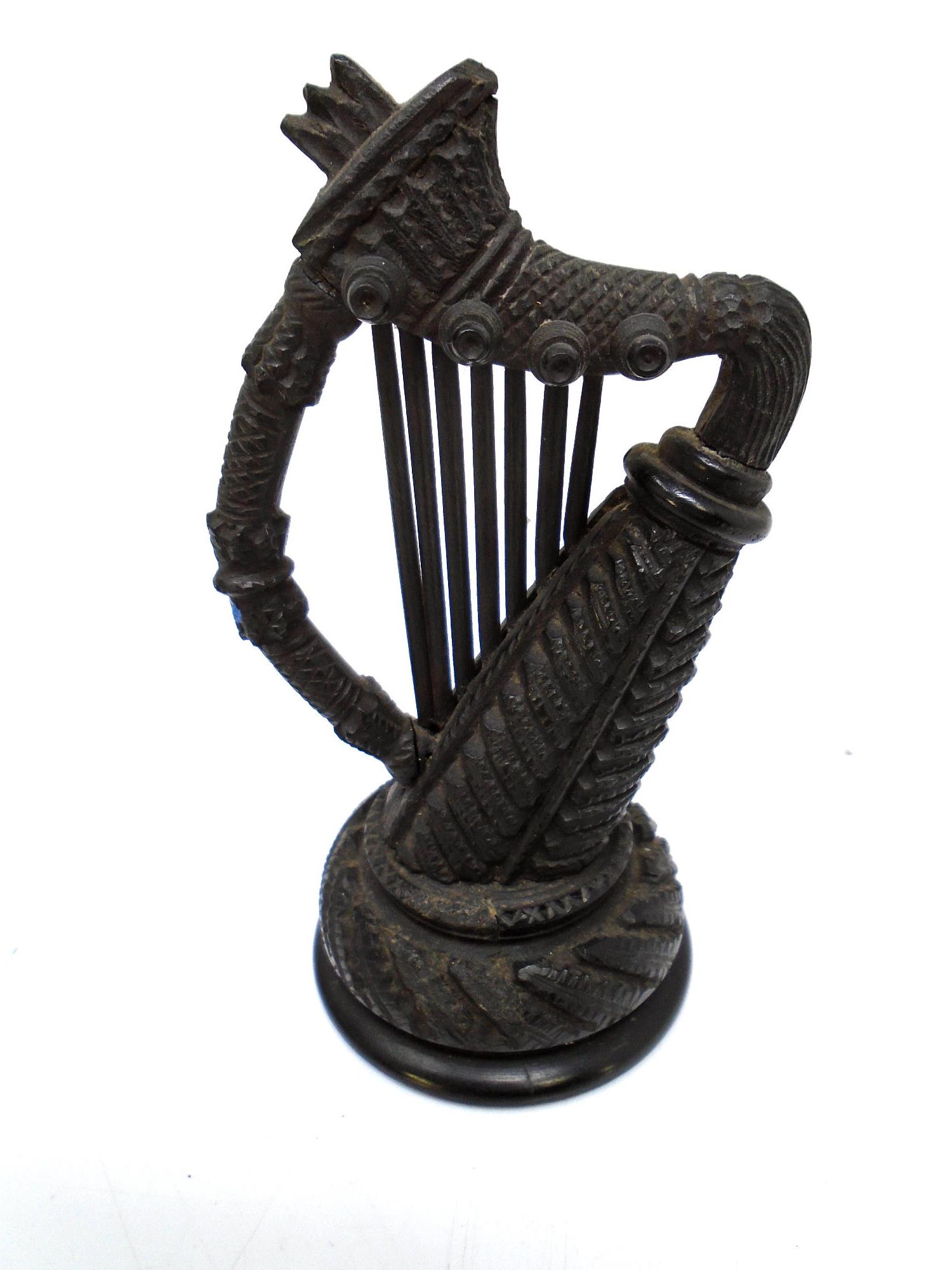 A Victorian bog oak carving of a harp.