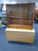 A 20th century teak storage blanket box together with a set of teak sliding glass door bookshelves