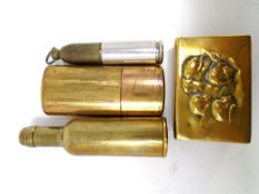 A vintage brass cased lighter in the form of a bottle together with a brass matchbox holder and two