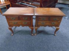 A pair of two drawer bedside chests on cabriole legs