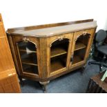 A 19th century walnut shaped fronted credenza on raised legs