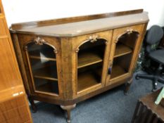 A 19th century walnut shaped fronted credenza on raised legs