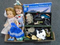 A box containing Revell modelling kit of a Typhoon, mid-20th century dolls,