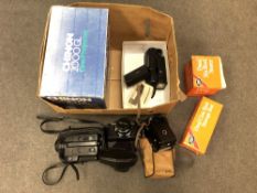A box of vintage film cameras and camera equipment including flash,