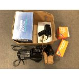 A box of vintage film cameras and camera equipment including flash,