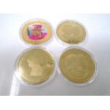 Four gold plated Queen Elizabeth II commemorative coins.