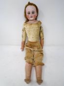 A Victorian bisque-headed jointed doll.