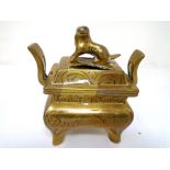 A Chinese brass lidded censer.