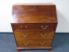 A Victorian mahogany two-over-two four drawer writing bureau.