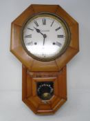 An antique Ansonia pine cased wall clock.