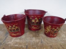 A set of three graduated metal buckets bearing Coca-cola advertising.