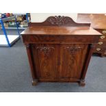 A Victorian mahogany double door cabinet fitted with drawers above and pillar column supports.