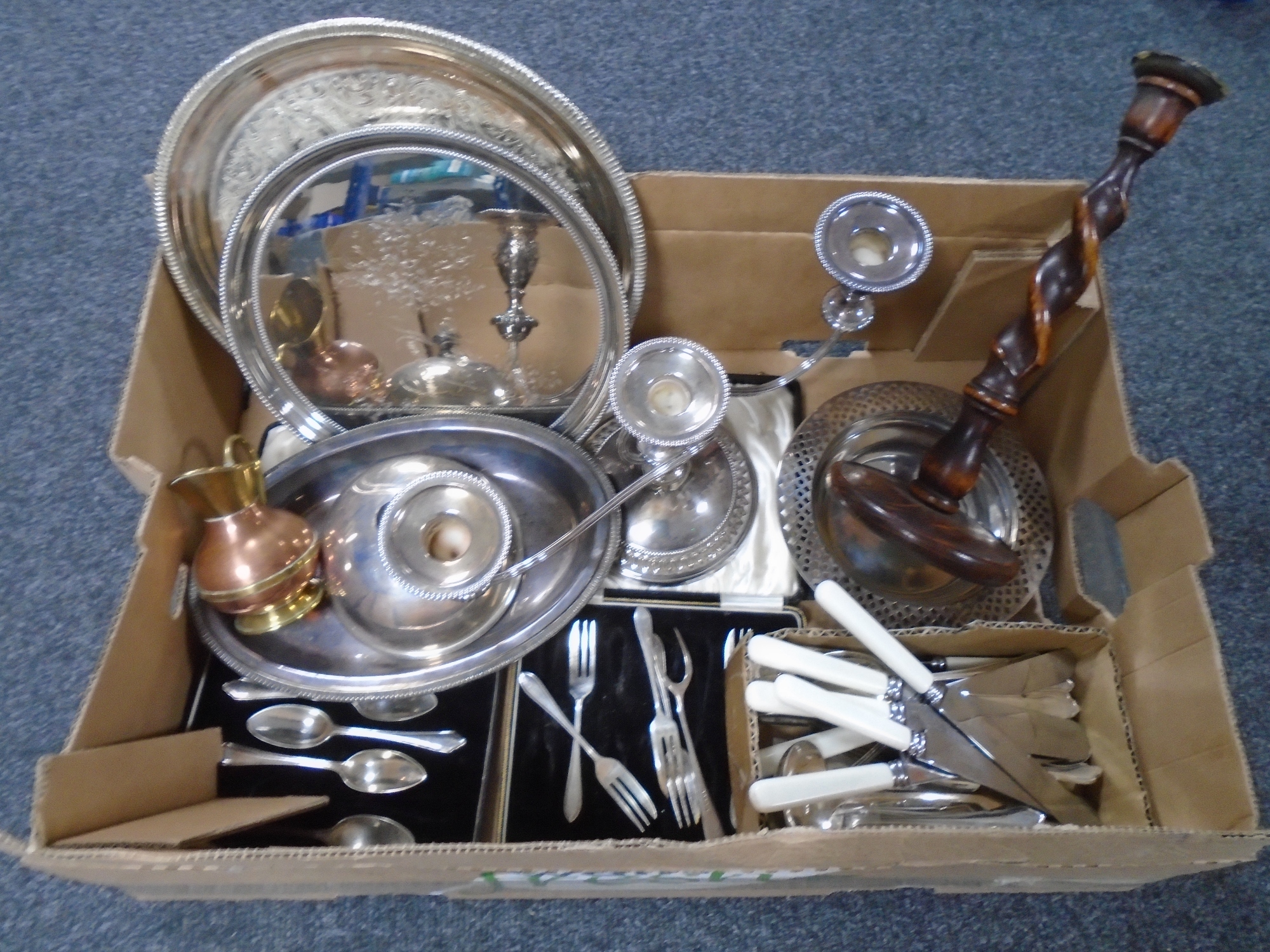 A box of plated wares including cutlery, three sconce table candelabrum, serving trays,