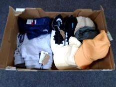 A box containing a pair of Under Armour Hover trainers, Tommy Hilfiger jogging bottoms and t-shirt,