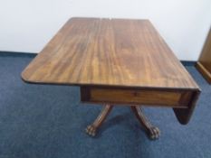 A 19th century mahogany flap sided table fitted with a drawer on a four way pedestal.