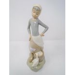 A Lladro figure, girl on milking stool.