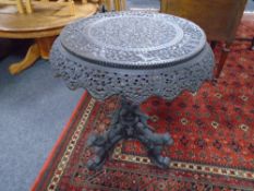A 19th century heavily carved Anglo-Indian occasional table on pedestal base.