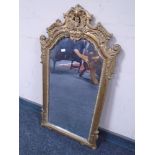 A decorative mirror in gilt frame.