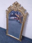 A decorative mirror in gilt frame.