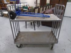 A metal two tier trolley together with a newspaper trolley.