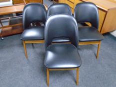 A set of four 20th century Centa teak leg dining chairs upholstered in black vinyl.