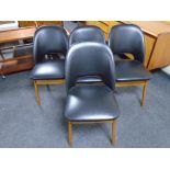 A set of four 20th century Centa teak leg dining chairs upholstered in black vinyl.