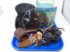 A tray containing antique field glasses, top hat, Polaroid camera, rustic pipe etc.