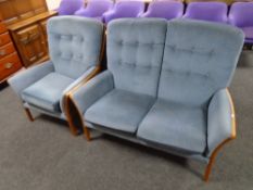 A 20th century Parker Knoll wood framed two seater settee and armchair upholstered in blue fabric.
