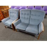 A 20th century Parker Knoll wood framed two seater settee and armchair upholstered in blue fabric.