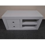 A painted contemporary entertainment stand fitted with shelves and two drawers.