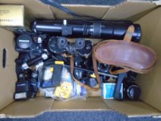 A box containing a set 7x50 field glasses in case, Olympus AF Zoom camera, assorted lenses,