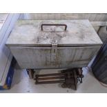 A galvanized metal box on castors containing pulleys, chains, hydraulic pumps,