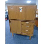 A 20th century teak effect Schreiber secretaire cabinet fitted with cupboard and drawers beneath.