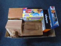 A box containing board games together with three pine shoe shine boxes.