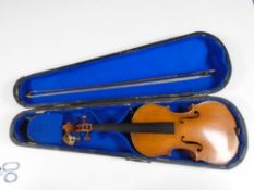 An early 20th century French Medio Fino violin, with bow stamped 'Germany', in coffin case.