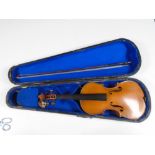 An early 20th century French Medio Fino violin, with bow stamped 'Germany', in coffin case.