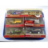 A tray of six boxed Matchbox models of yesteryear die cast wagons and busses together with one