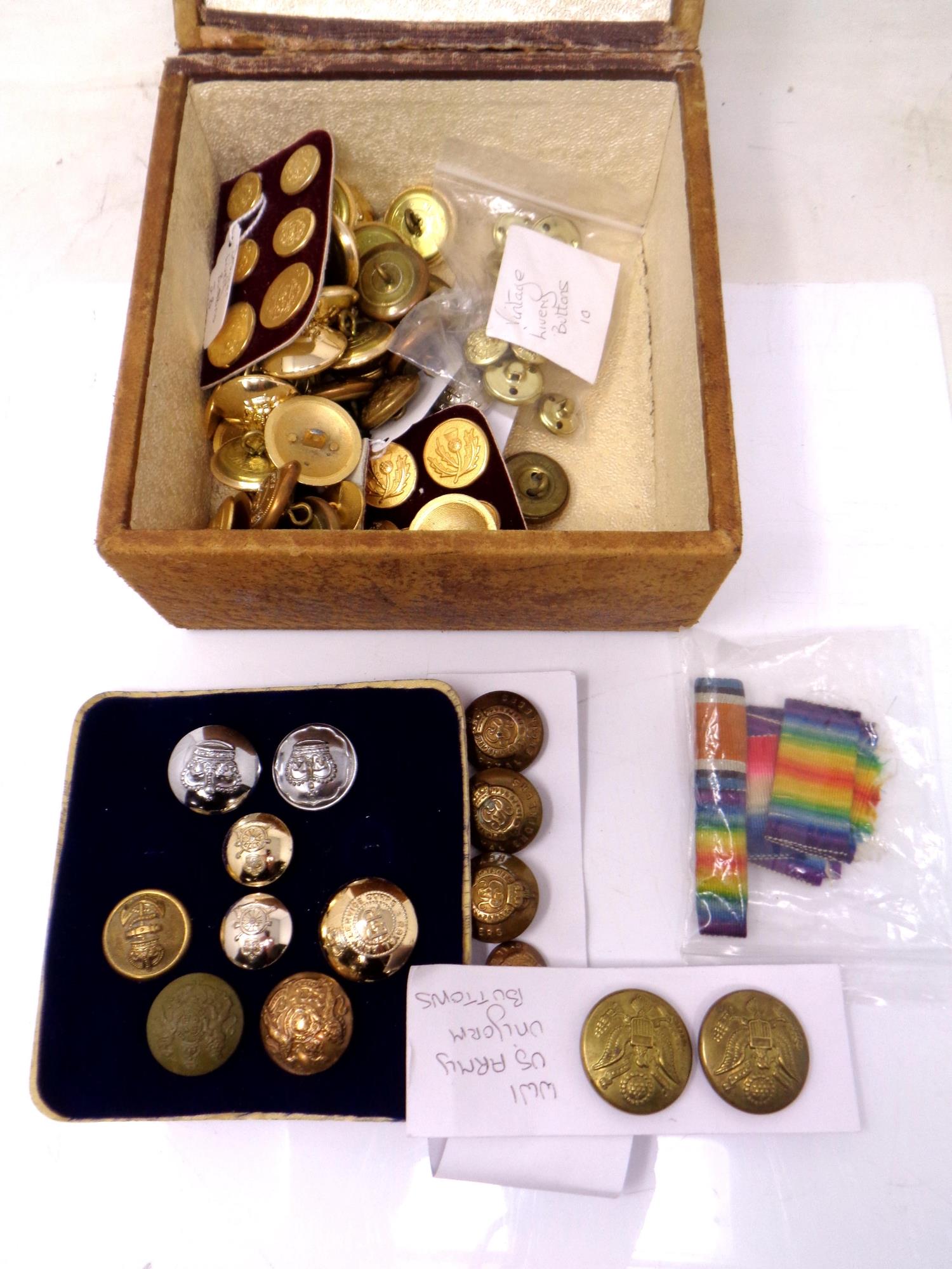 A tooled leather box containing military buttons.