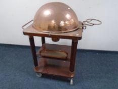 A 20th century three tier food cart with copper cloche, burner and inset plated turkey dish.