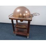 A 20th century three tier food cart with copper cloche, burner and inset plated turkey dish.