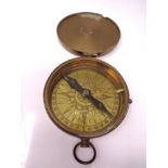 A brass pocket compass.